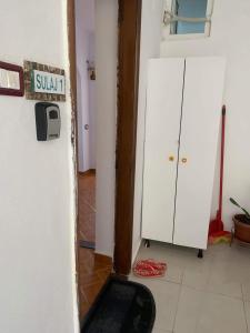 a room with a refrigerator with a sign on it at Sulaj Sea View 1 in Himare +8 photos