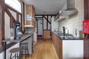 a kitchen with a counter and a stove top oven at The Red House Maldon in Maldon