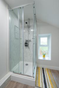 a shower stall in a bathroom with a window at 3 bedroom Cannock flat ideal for groups in Great Wyrley