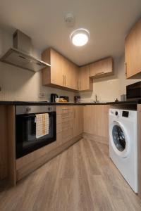 a kitchen with a washer and a washing machine at 3 bedroom Cannock flat ideal for groups in Great Wyrley