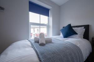 a bedroom with a bed with a towel on it at 3 bedroom Cannock flat ideal for groups in Great Wyrley