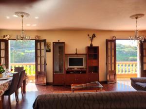 a living room with a couch and a tv at Gomes house in Ponta do Sol