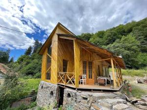 a small wooden house on a rock at Korsha Guesthouse in Roshka
