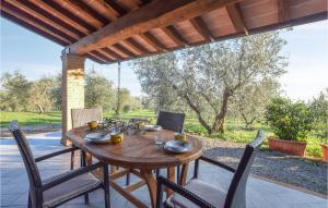 a wooden table and chairs on a patio at Casa Giannini in Magliano in Toscana