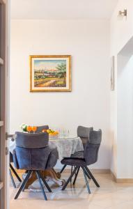 a dining room with a table and three chairs at Four Hills Apartment in Žrnovnica