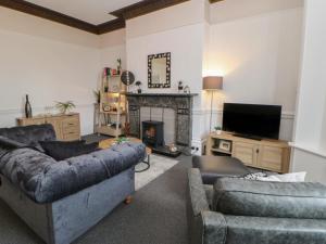 a living room with a couch and a fireplace at Grand Sea View in North Shields