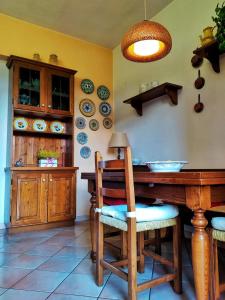 a dining room with a wooden table and plates on the wall at Casa Dina in San Gimignano