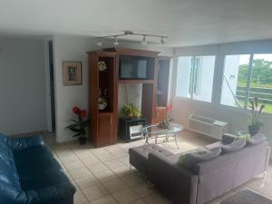 a living room with a couch and a table at Relaxing Hillside Village Apartment in Rio Grande