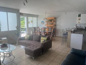 a living room with a couch and a table at Relaxing Hillside Village Apartment in Rio Grande