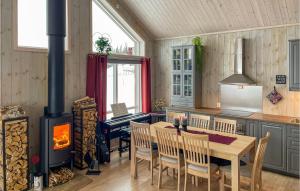 a kitchen with a table and a wood stove at 3 Bedroom Stunning Home In Aurdal in Aurdal