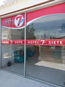 a reflection of a hotel z site sign in a store window at Hotel 7 in Cúcuta