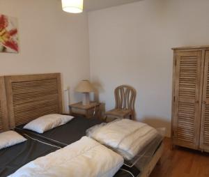 a bedroom with two beds and a chair in it at Le Sea Breeze La Rochelle 44m2 - 2 chambres - 6 prs - Piscine in Lagord
