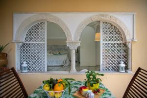 a table with a bowl of fruit in front of a mirror at Casa La Bifora Positano in Positano