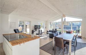 cocina y sala de estar con mesa y sillas en 5 Bedroom Cozy Home In Vggerlse, en Bøtø By