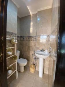 a bathroom with a sink and a toilet and a shower at CosyApp in Agadir