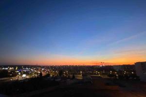 a view of a city at night with lights at CosyApp in Agadir