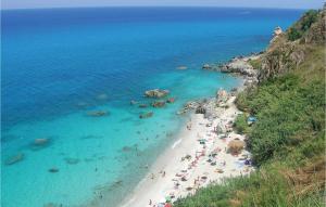 a group of people on a beach near the ocean at Casa Nardi in Parghelia