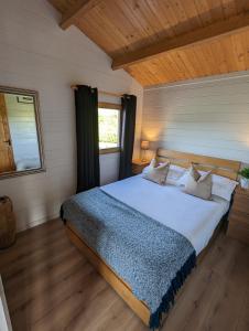 a bedroom with a large bed in a room at Westport Country Chalets in Westport