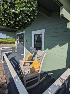 two chairs sitting on the porch of a house at Westport Country Chalets in Westport