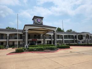 a building with a clock tower on top of it at Express Inn Tomball in Tomball