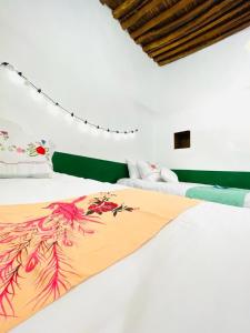 2 Betten in einem Zimmer mit weißen Wänden in der Unterkunft Seventies السبعينات in Sawdāʼ