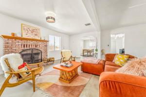 a living room with a couch and a fireplace at The Maude House in Twentynine Palms