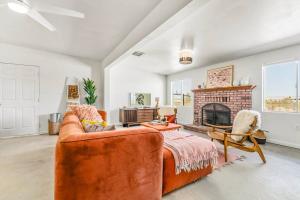 a living room with a couch and a fireplace at The Maude House in Twentynine Palms