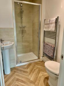 a bathroom with a shower and a toilet and a sink at The Graph’s Gaff 