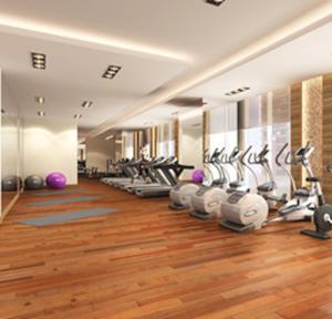 a gym with a row of treadms and machines at Brand New Apartment with Gym and Pool in Dubai