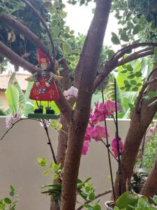 a statue of a girl sitting in a tree at Casa d' Avó Zeza in Jardim do Mar +80 photos