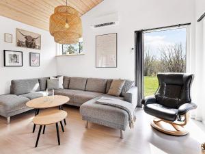 a living room with a couch and a chair and a table at 10 person holiday home in Glesborg in Glesborg