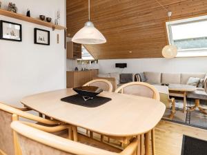 una sala da pranzo e un soggiorno con tavolo e sedie. di 4 person holiday home in Idestrup a Bøtø By