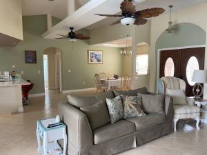 a living room with a couch and a kitchen at Pool Home in Englewood