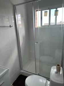 uma casa de banho branca com um chuveiro e um WC. em El Gengo Hostel em Madri