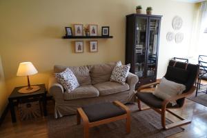 a living room with a couch and two chairs at ALMAR, Apartamento en Luanco. in Luanco