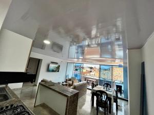 a living room with a piano and a dining room at APARTAMENTO FULL HOUSE con BALCON in El Colegio