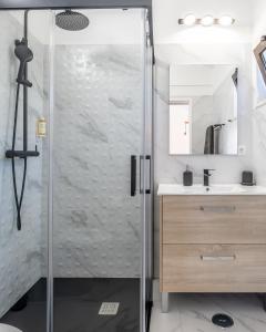 a shower with a glass door in a bathroom at Flow Rooms in Comporta