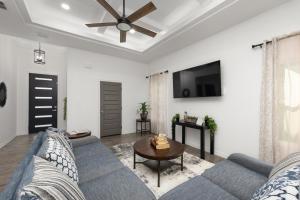 a living room with a blue couch and a table at Spacious Modern 3 Bd 2Ba House with Garage and Parking in Edinburg