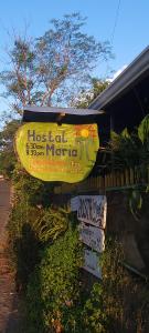 a sign for a hostel with signs on it at Hostal Maria in Rivas