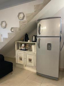 a kitchen with a refrigerator and a staircase at Departamento Lestani in Resistencia