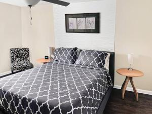 a bedroom with a black and white bed and a table at 3 bedroom comfy RVA in Richmond