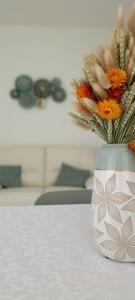 a vase with flowers in it sitting on a table at A Domo Tua in Alghero