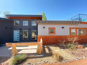 a house with a bench in front of it at Timber & Tin D 2Bed 2Bath w Pool & Rooftop Deck in Kanab