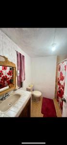 a bathroom with a white sink and a toilet at Home Sweet Home Guanajuato in Guanajuato