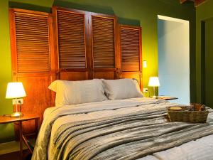 a bedroom with a large bed with a wooden headboard at Tranquil Master Suite, Your Private Escape in Medellín