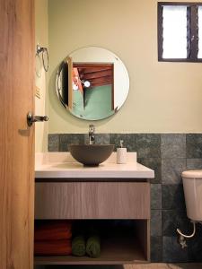 a bathroom with a sink and a mirror at Tranquil Master Suite, Your Private Escape in Medellín