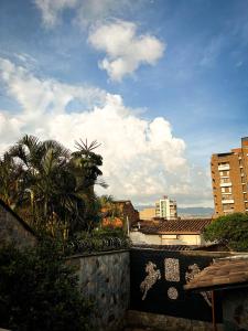 a view of a city with buildings and palm trees at Tranquil Master Suite, Your Private Escape in Medellín