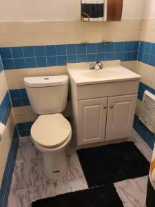 a bathroom with a white toilet and a sink at Entire Apt in Chester 