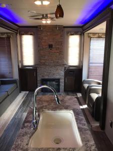 a kitchen with a sink and a fireplace at Orchard Queen Motel & Rv Park in Middleton