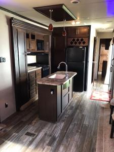 a kitchen with a sink and a counter top at Orchard Queen Motel & Rv Park in Middleton